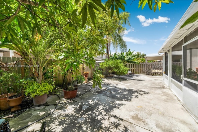 view of patio with a sunroom and a fenced backyard