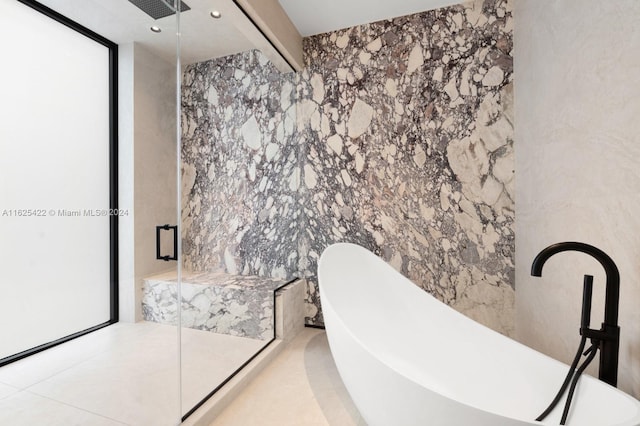 bathroom featuring tile patterned floors, separate shower and tub, and tile walls