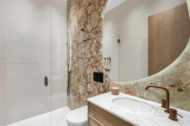 bathroom with vanity, toilet, an enclosed shower, and tile walls