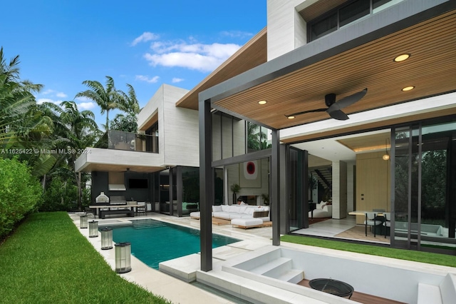 rear view of house featuring ceiling fan, a balcony, an outdoor hangout area, and a patio