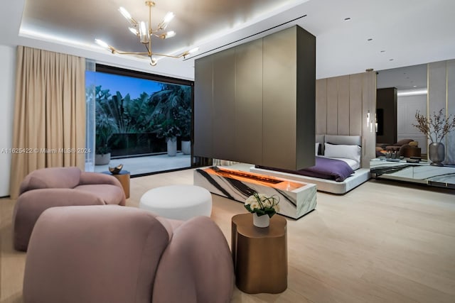 cinema room with light wood-type flooring and a chandelier