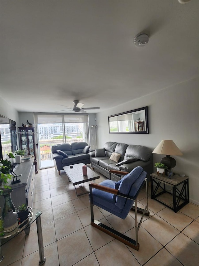 living area featuring a ceiling fan and light tile patterned floors