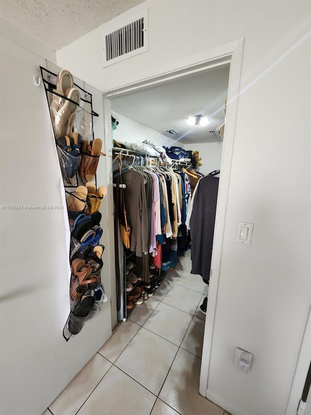spacious closet featuring light tile patterned flooring and visible vents