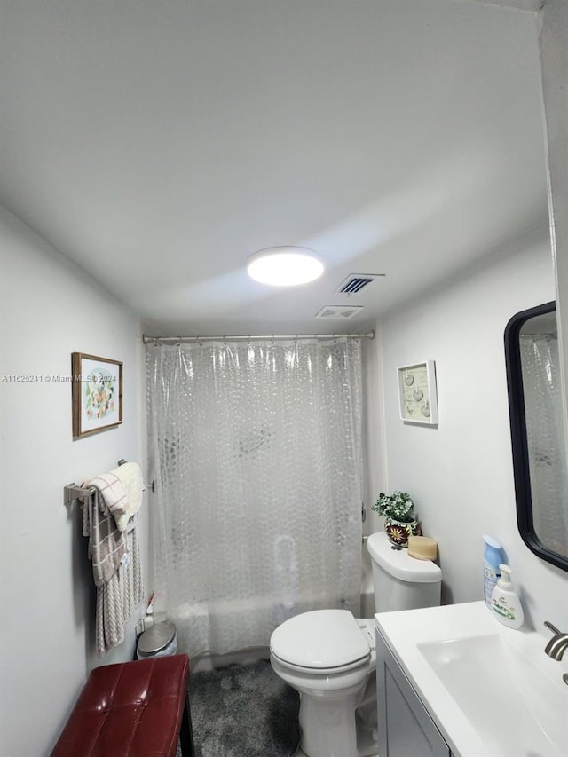 bathroom with shower / tub combo, toilet, and vanity