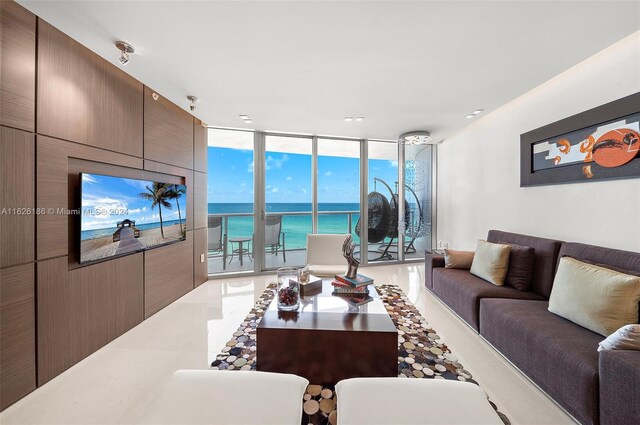 tiled living room featuring floor to ceiling windows