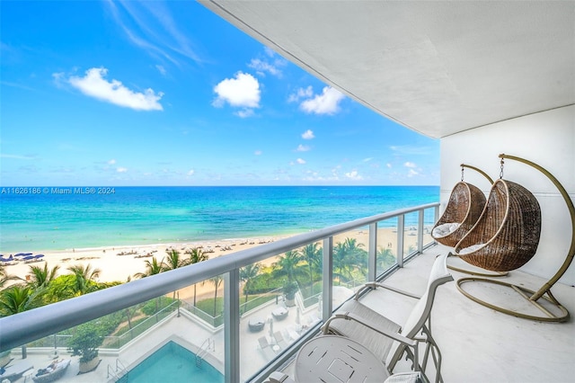 balcony with a beach view and a water view