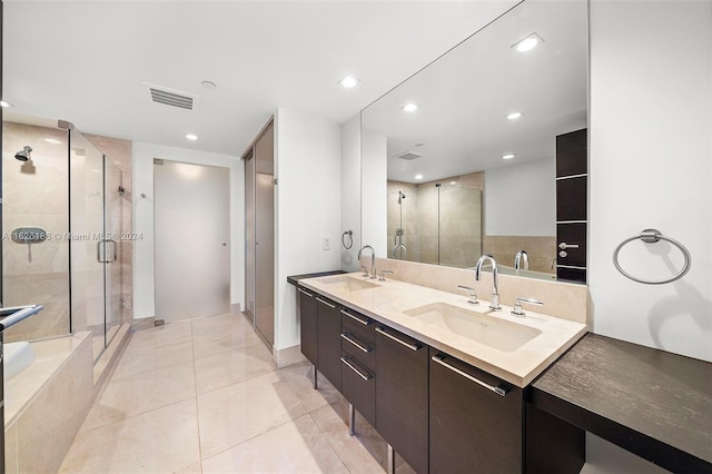 bathroom with vanity, tile patterned flooring, and a shower with door