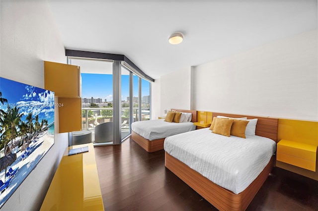 bedroom with dark hardwood / wood-style flooring, access to outside, and floor to ceiling windows