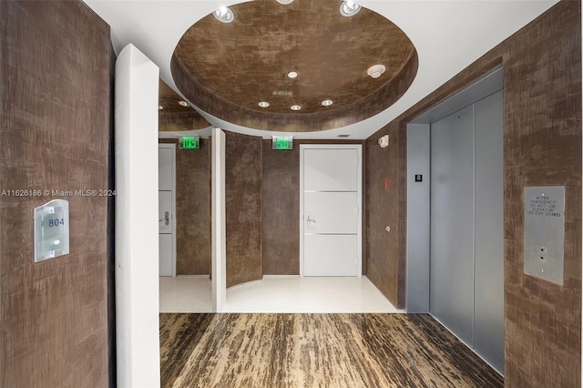 bathroom with hardwood / wood-style flooring and elevator