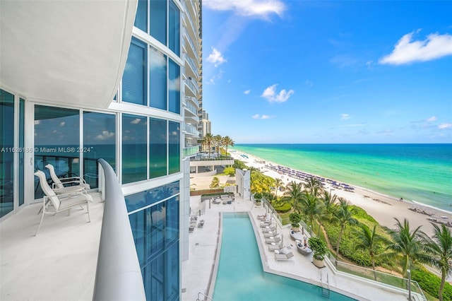 exterior space with a water view, a beach view, and a patio area