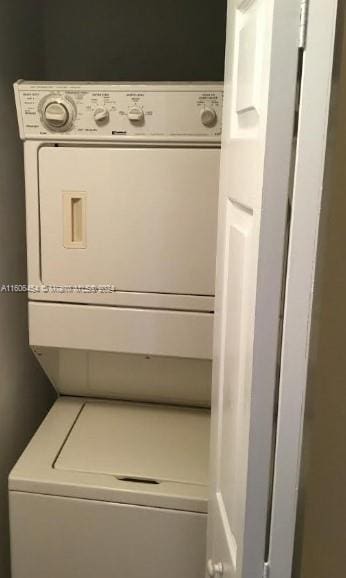 laundry room featuring stacked washer / drying machine