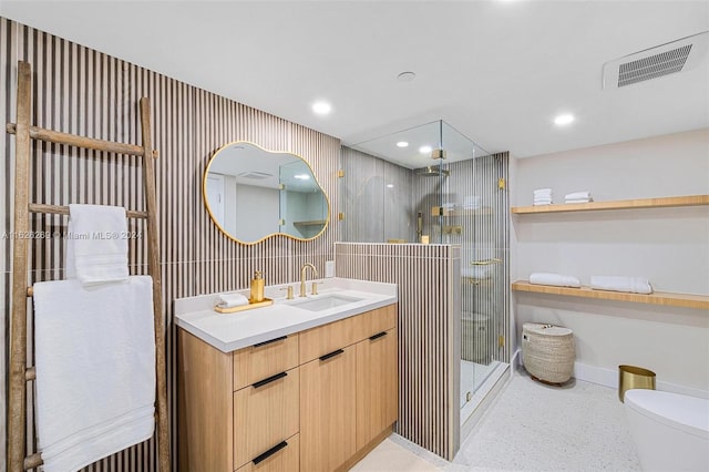 bathroom featuring vanity, a shower with shower door, and toilet