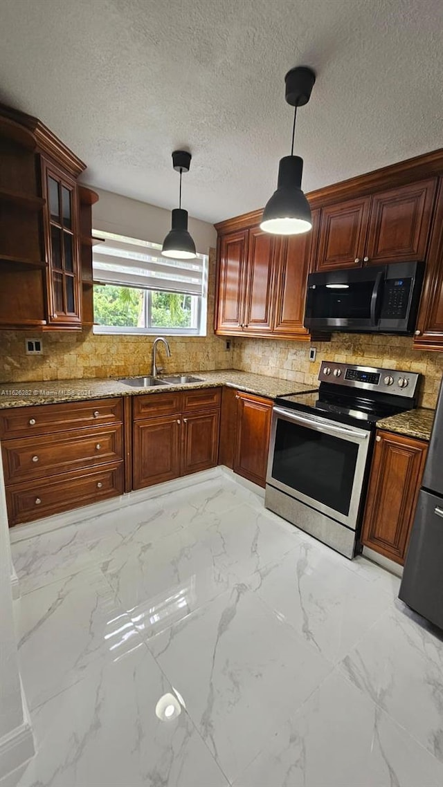 kitchen with pendant lighting, light stone countertops, sink, and electric range