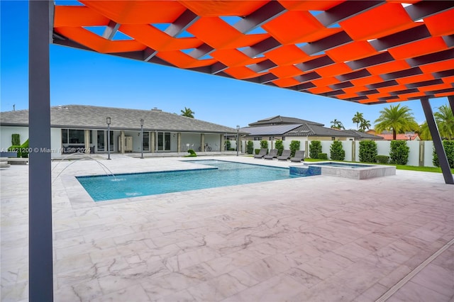 view of swimming pool with an in ground hot tub, pool water feature, and a patio area