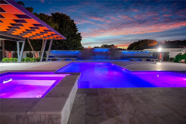 pool at dusk featuring a patio area