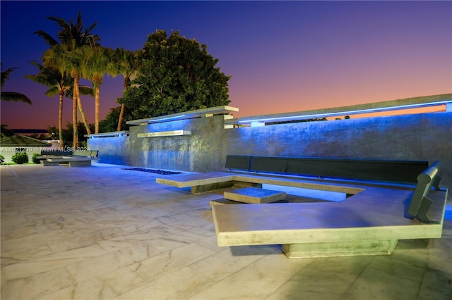 pool at dusk with a patio