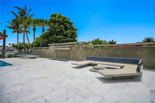 view of swimming pool with a patio and pool water feature