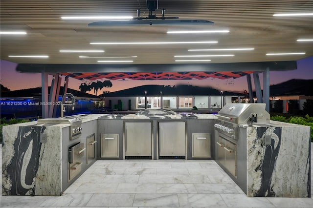 view of patio with grilling area and an outdoor kitchen