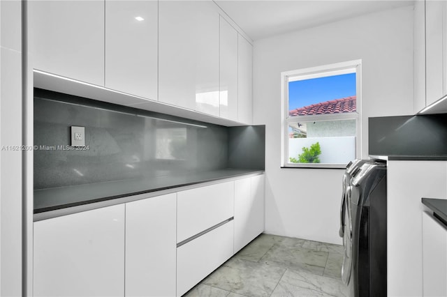 kitchen with white cabinetry and independent washer and dryer