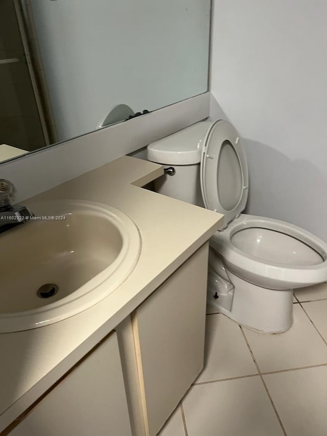 bathroom with vanity, toilet, and tile patterned floors