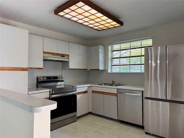 kitchen with stainless steel appliances, light countertops, a sink, and under cabinet range hood