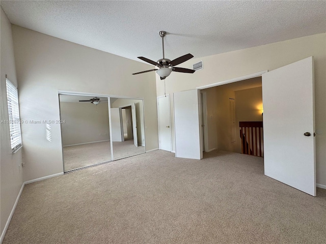 unfurnished bedroom with carpet, a closet, visible vents, a ceiling fan, and a textured ceiling