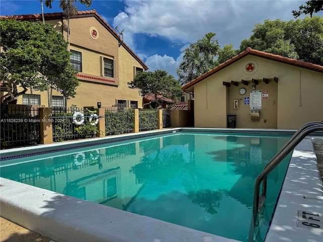 community pool featuring fence