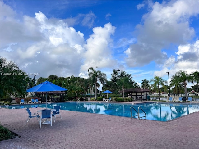 community pool featuring a gazebo and a patio