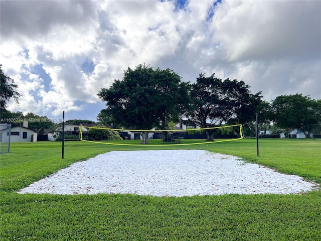 surrounding community featuring volleyball court and a yard