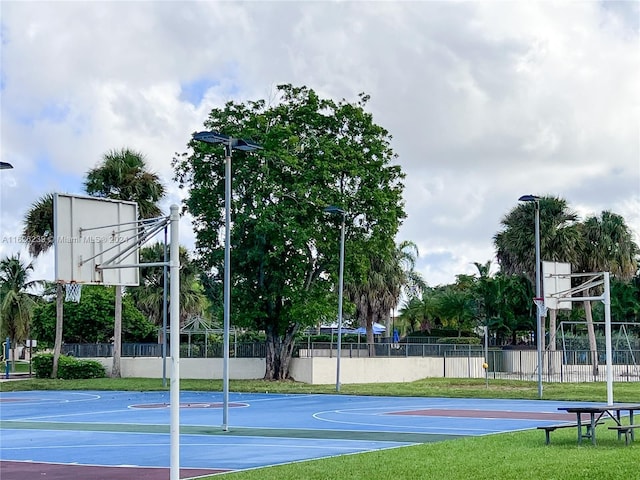 view of basketball court featuring community basketball court and fence