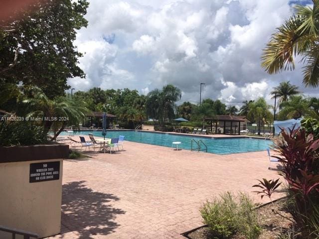 community pool featuring a patio area and fence