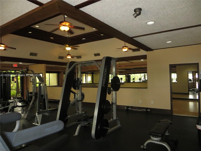 exercise room featuring a textured ceiling, visible vents, and baseboards