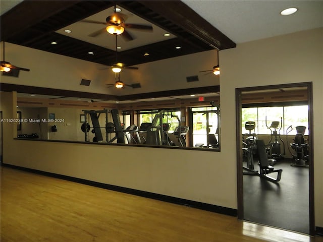 workout area featuring wood finished floors, visible vents, and baseboards