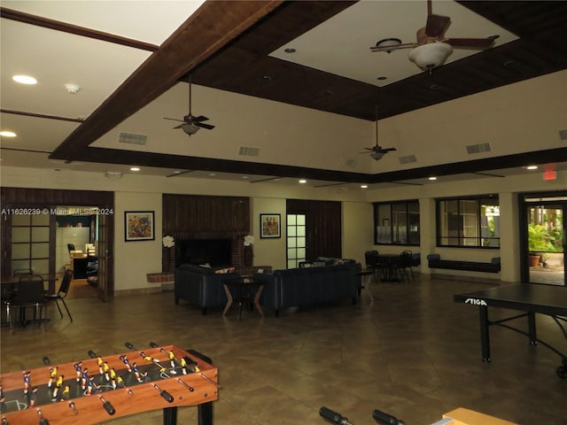 rec room with ceiling fan, a fireplace, and visible vents