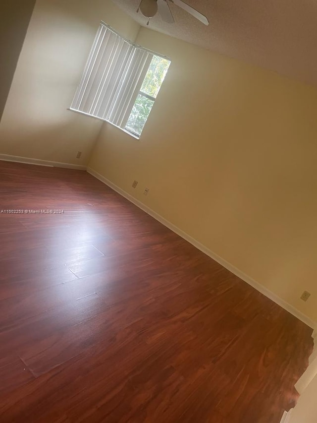 bonus room with wood-type flooring and ceiling fan