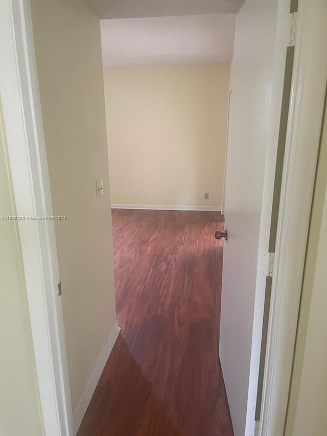 hallway with hardwood / wood-style floors