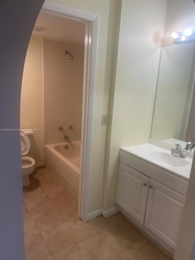 full bathroom featuring vanity, tiled shower / bath combo, toilet, and tile patterned floors