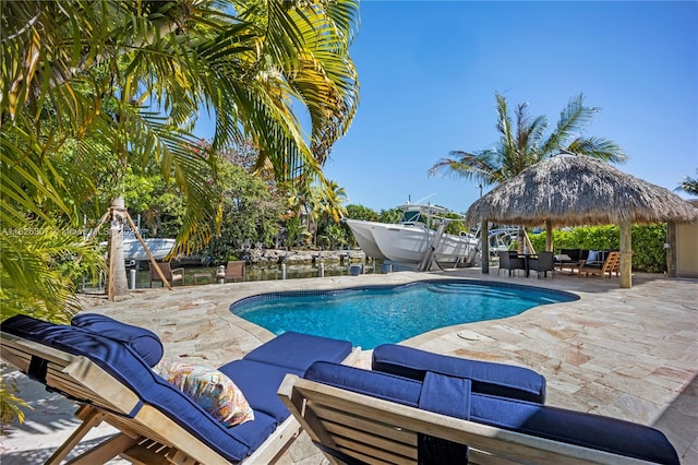 view of pool featuring a patio, a gazebo, and an outdoor living space