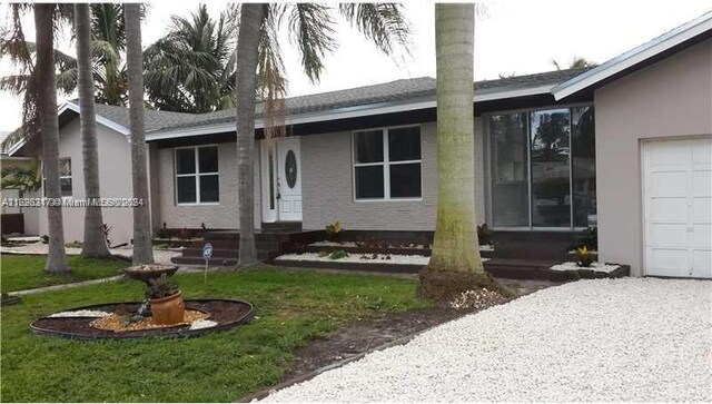 view of front of home featuring a garage and a front lawn