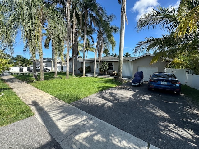 single story home with a garage and a front yard