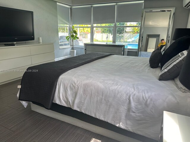 bedroom featuring a wall mounted air conditioner