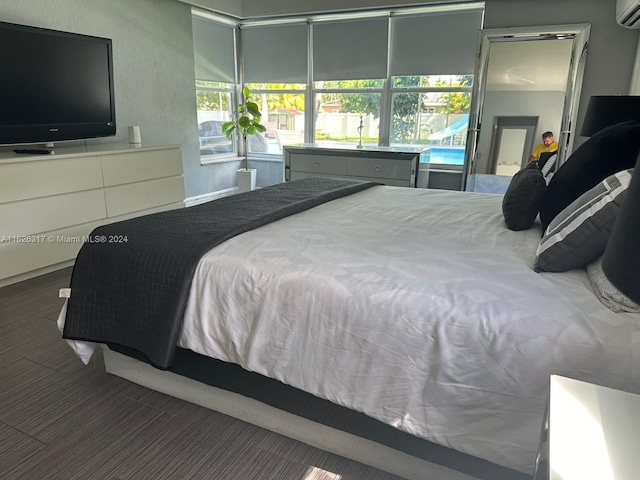 bedroom featuring a wall mounted AC