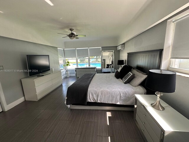 bedroom featuring a wall unit AC and ceiling fan