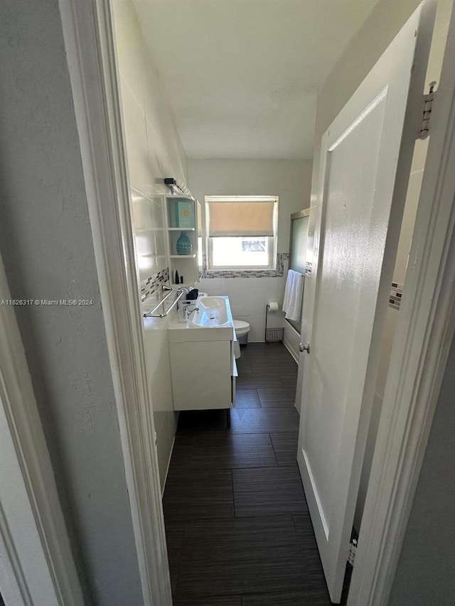 hall featuring radiator heating unit and dark tile patterned floors