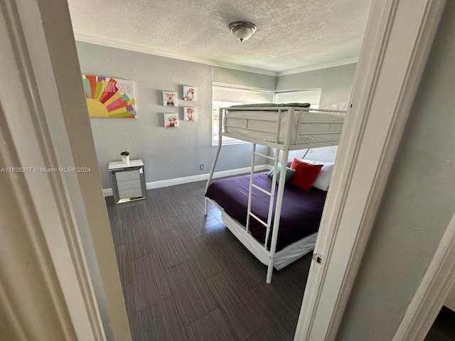 bedroom with ornamental molding and a textured ceiling