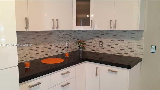 kitchen featuring decorative backsplash and white cabinets