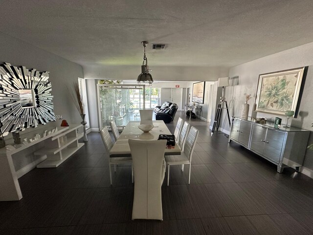 dining area featuring a textured ceiling