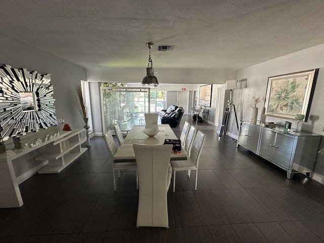 dining area with a textured ceiling