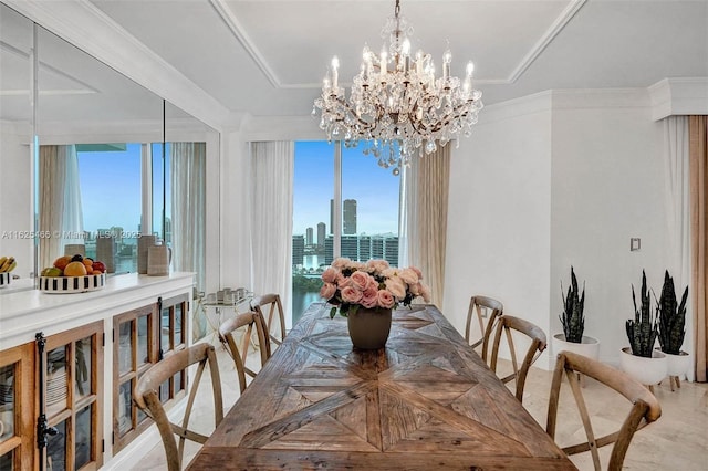 dining room with a city view, crown molding, and a notable chandelier