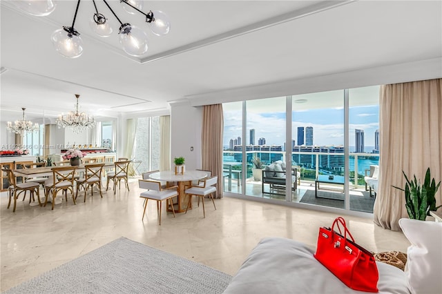 dining room featuring an inviting chandelier, a wall of windows, and a view of city